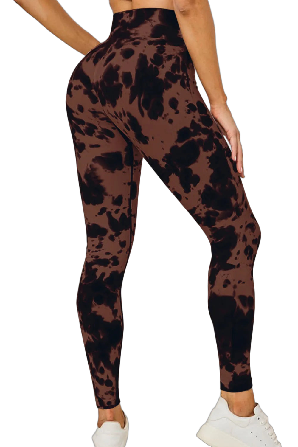 Rear three-quarter view of high-waist tie-dye leggings with dark irregular splotches; model wearing white sneakers