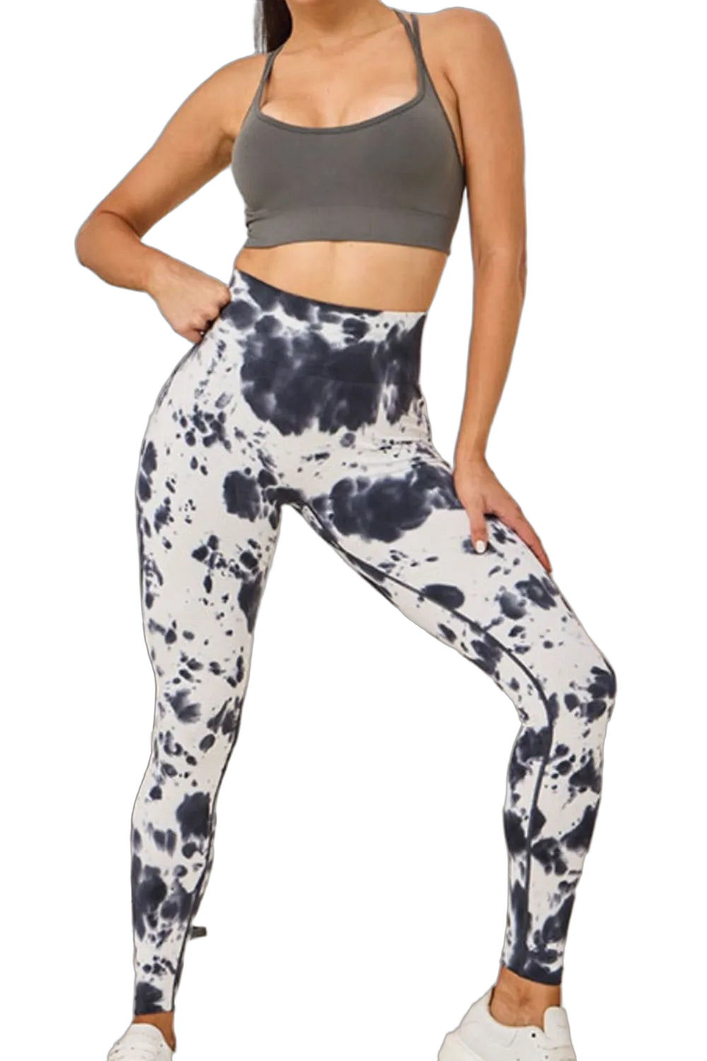 Model wearing high-waist black-and-white tie-dye leggings, gray sports bra, white sneakers