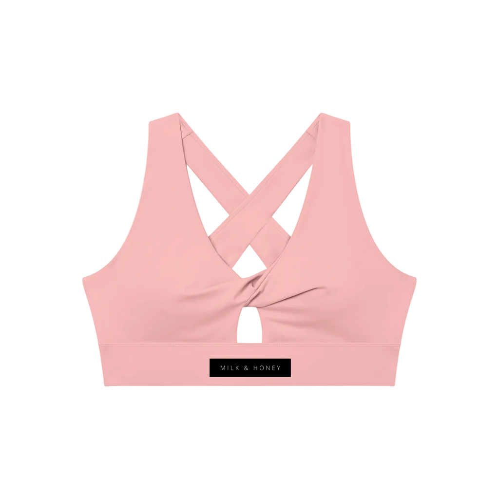 Pink twist-front sports bra with V-neck, crossed back straps, small front keyhole and 'MILK & HONEY' label on the band