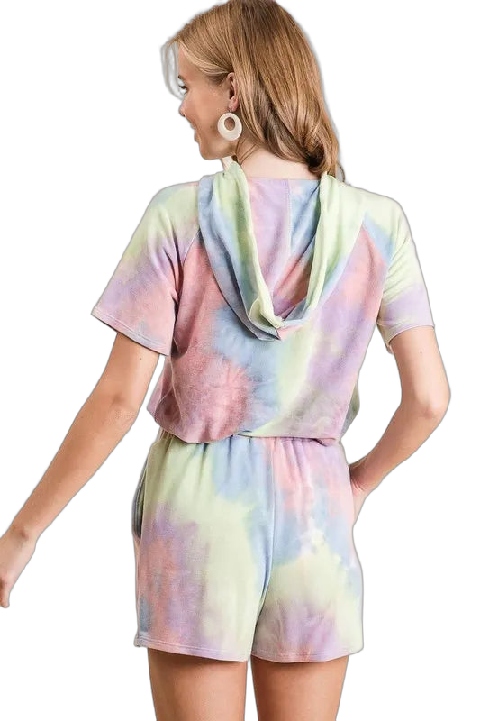 Model back view wearing pastel tie-dye hooded short-sleeve top and matching elastic-waist shorts with side pockets.