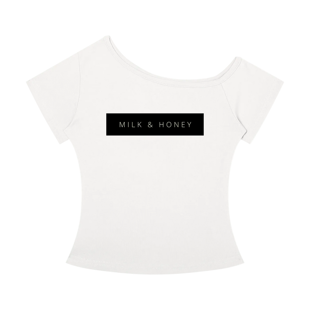 White off-the-shoulder T-shirt with black rectangular 'MILK & HONEY' chest print