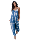 Model in sky-blue and white tie-dye V-neck jumpsuit with spaghetti straps, side pockets, beige platform sandals