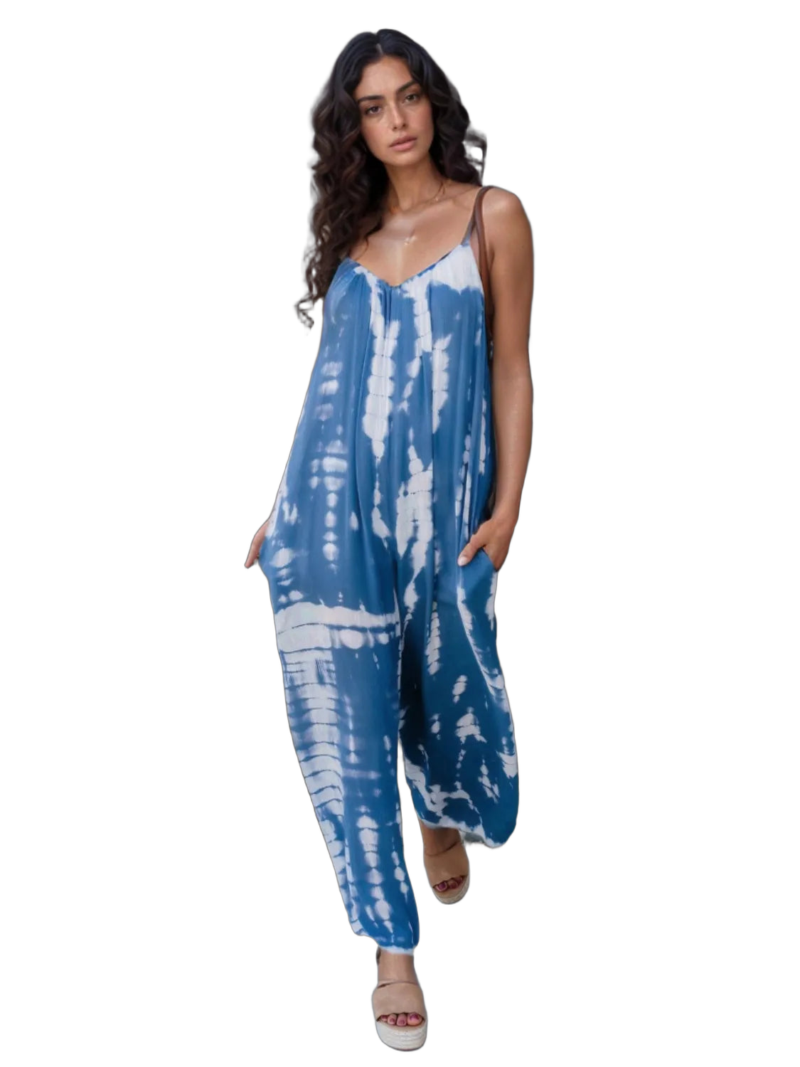 Model in sky-blue and white tie-dye V-neck jumpsuit with spaghetti straps, side pockets, beige platform sandals