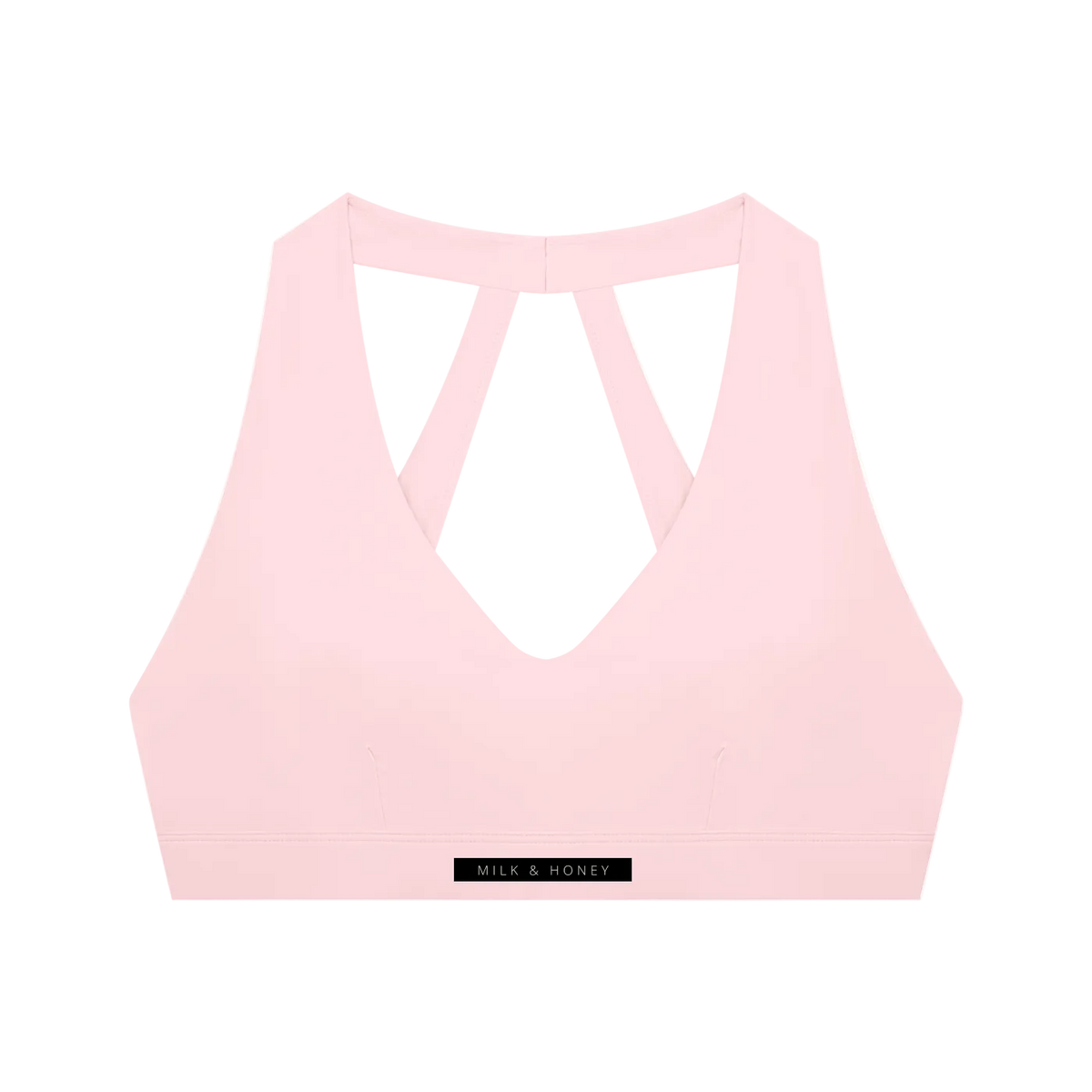 Light pink cropped sports bra with deep V-front, double straps forming a triangular back and MILK & HONEY hem label