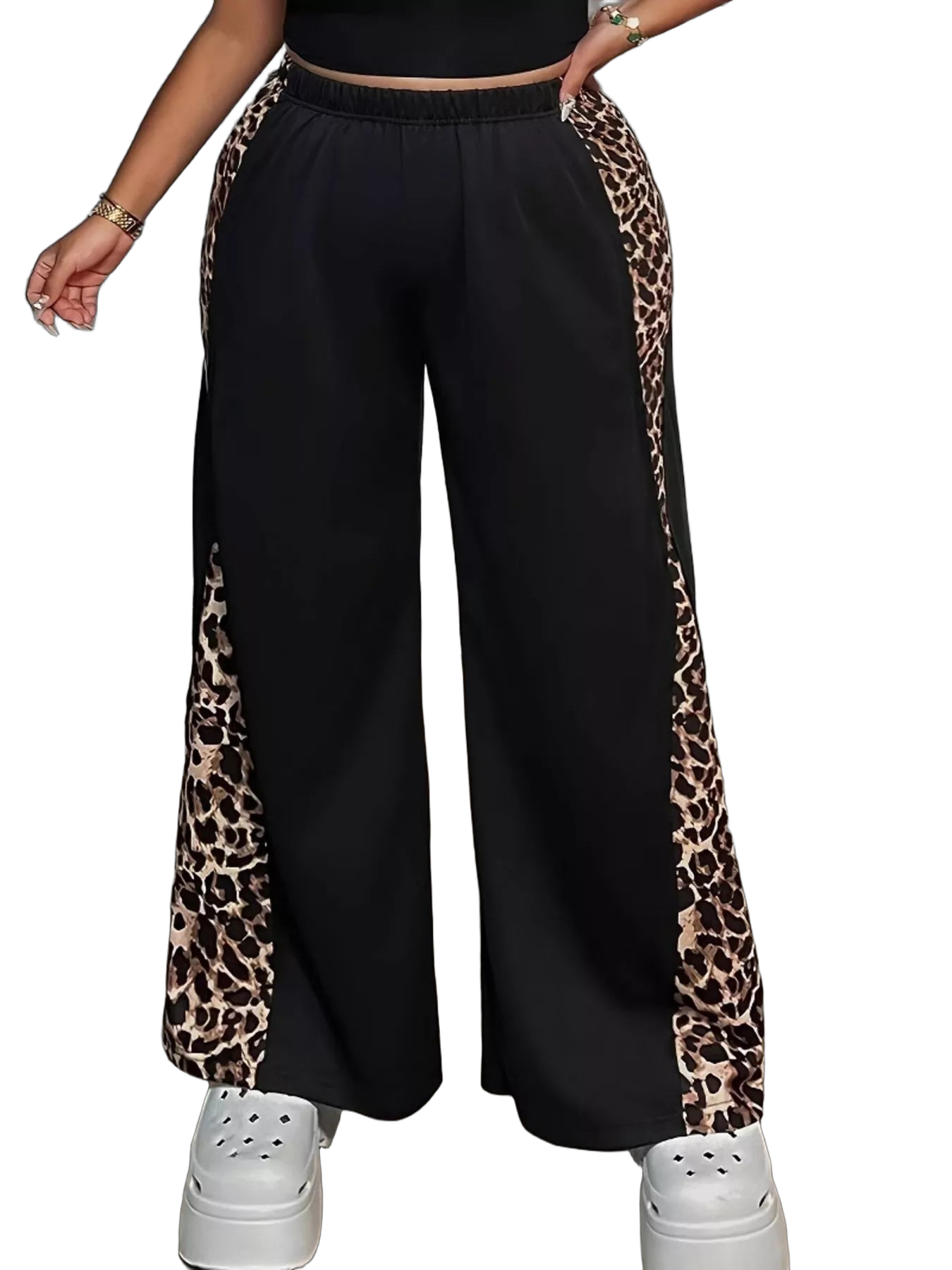 Black wide-leg pants with leopard-print side panels and elastic waistband; white platform shoes visible