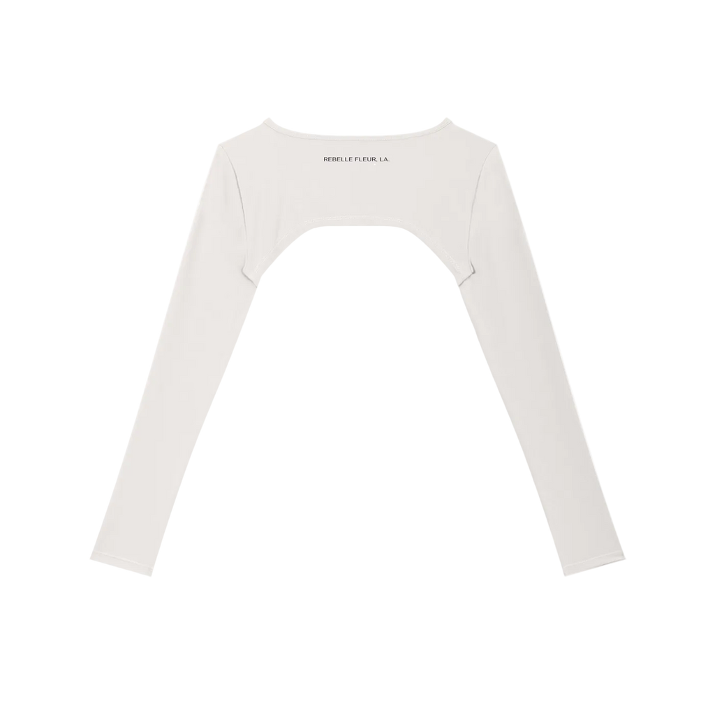 Cropped long-sleeve shrug with arched back cutout and small "REBELLE FLEUR, LA." text at upper back