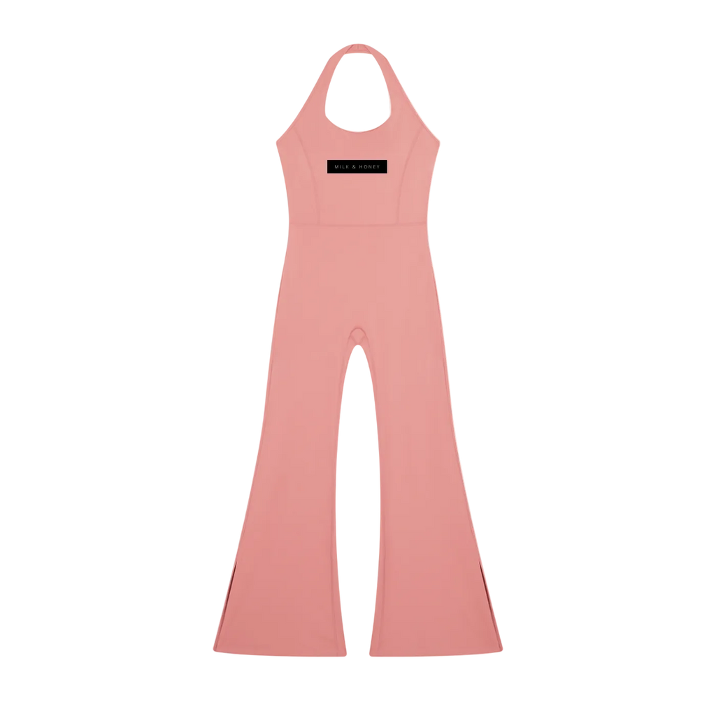 Pink halter-neck jumpsuit with fitted bodice, flared bell-bottom legs and black chest label reading 'MILK & HONEY'