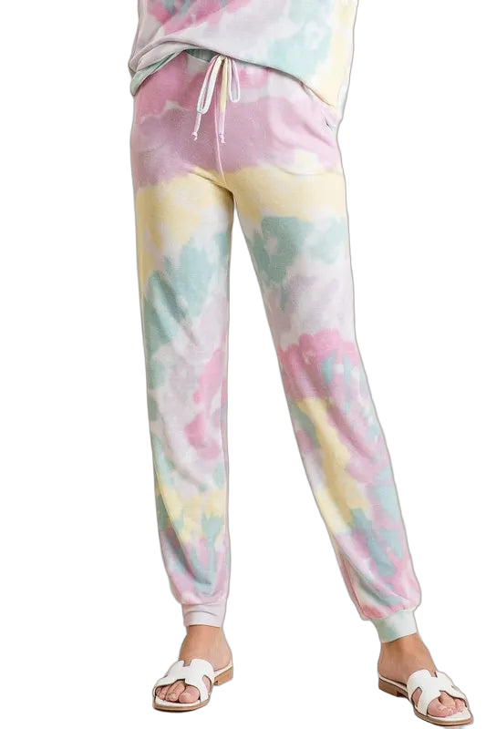 Lavender multi pastel tie-dye jogger pants with drawstring waist and cuffed ankles worn with white sandals