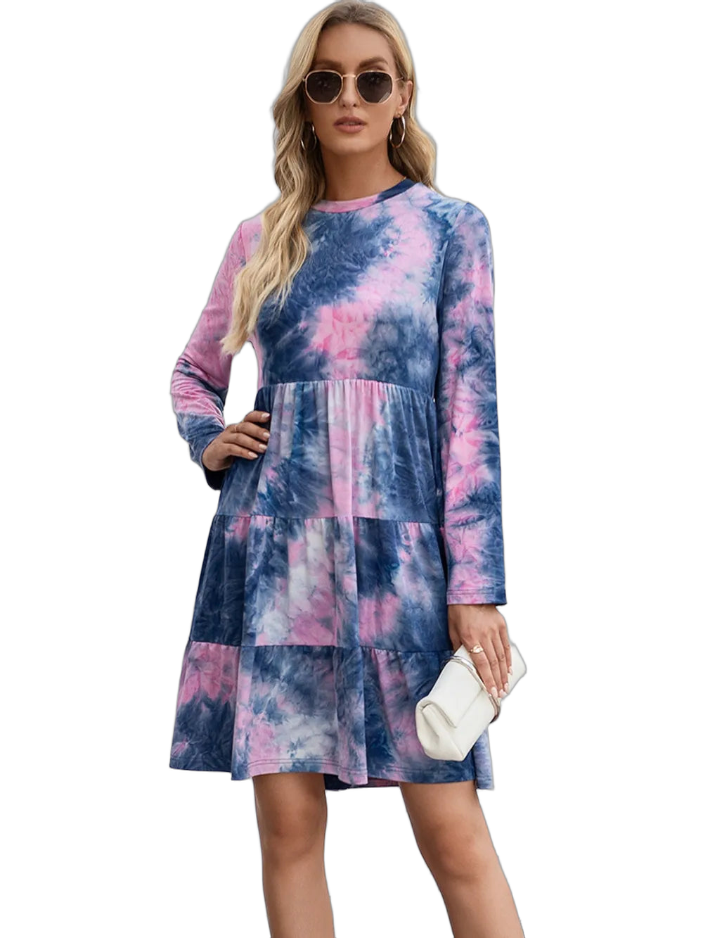 Model wearing long-sleeve dusty blue and pink tie-dye round-neck tiered dress holding white clutch
