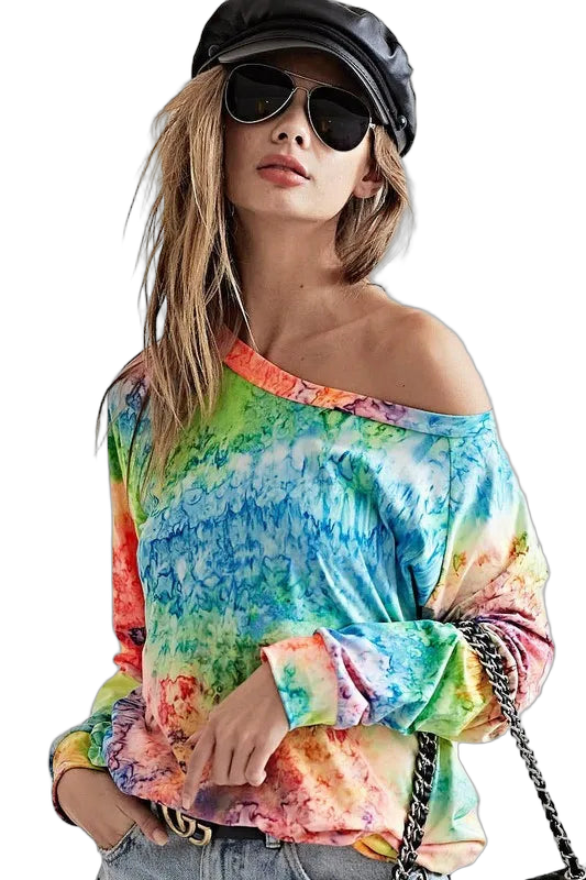 Female model wearing multicolor tie-dye long-sleeve off-shoulder top, aviator sunglasses, leather cap, chain-strap bag.
