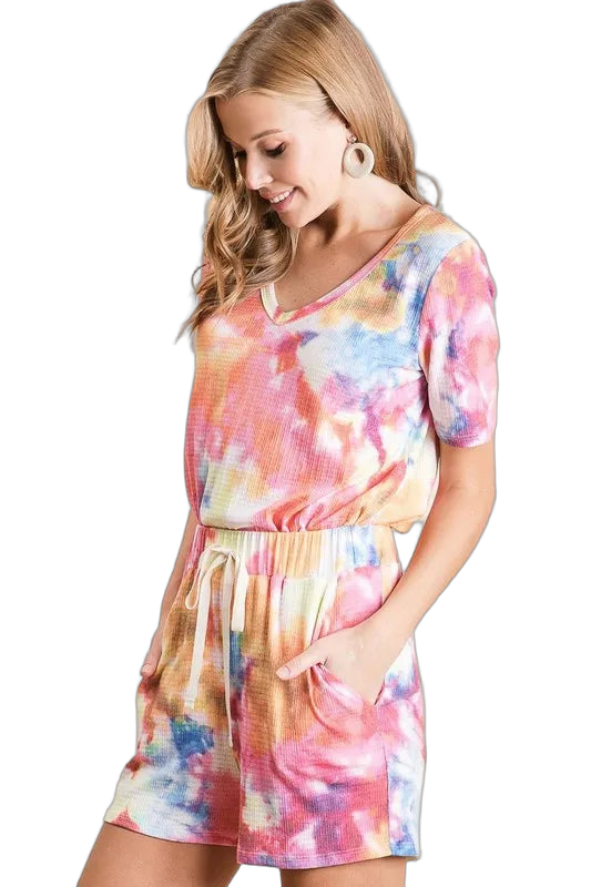 Model in multicolor tie-dye V-neck top with matching drawstring shorts and side pockets