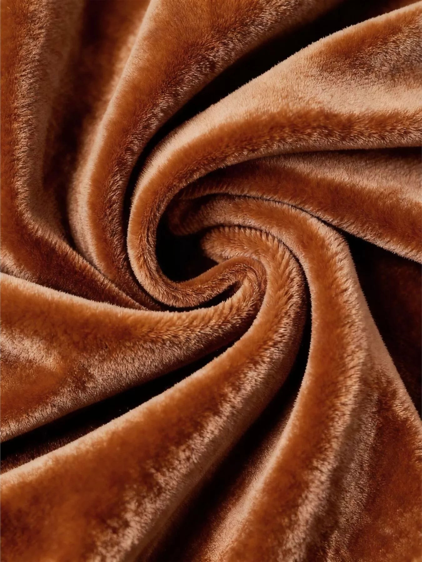 Caramel velvet fabric with plush pile folded into spiral swirls