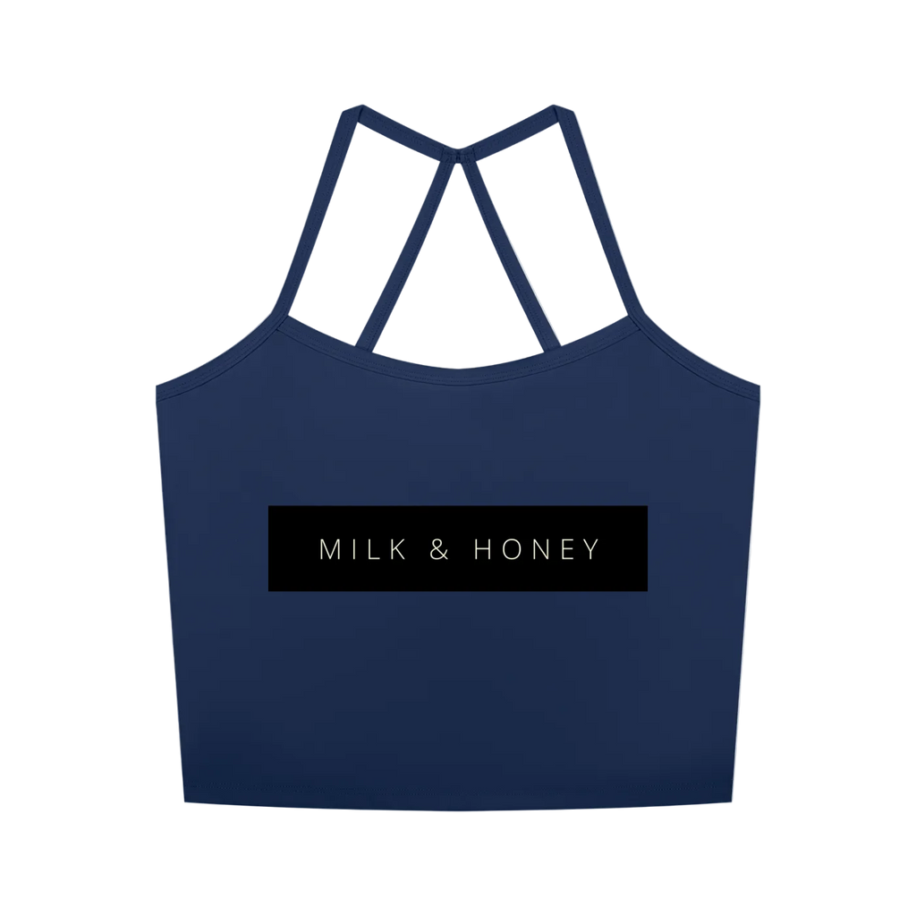 Navy cropped tank with thin crisscross back straps and centered black rectangle reading "MILK & HONEY"