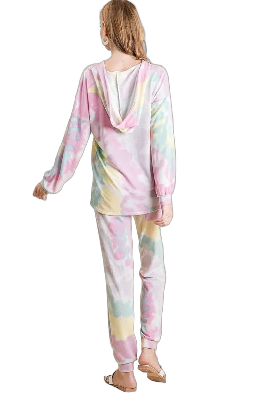 Back view of model wearing pastel pink, yellow and blue tie-dye French terry hooded top and matching jogger pants