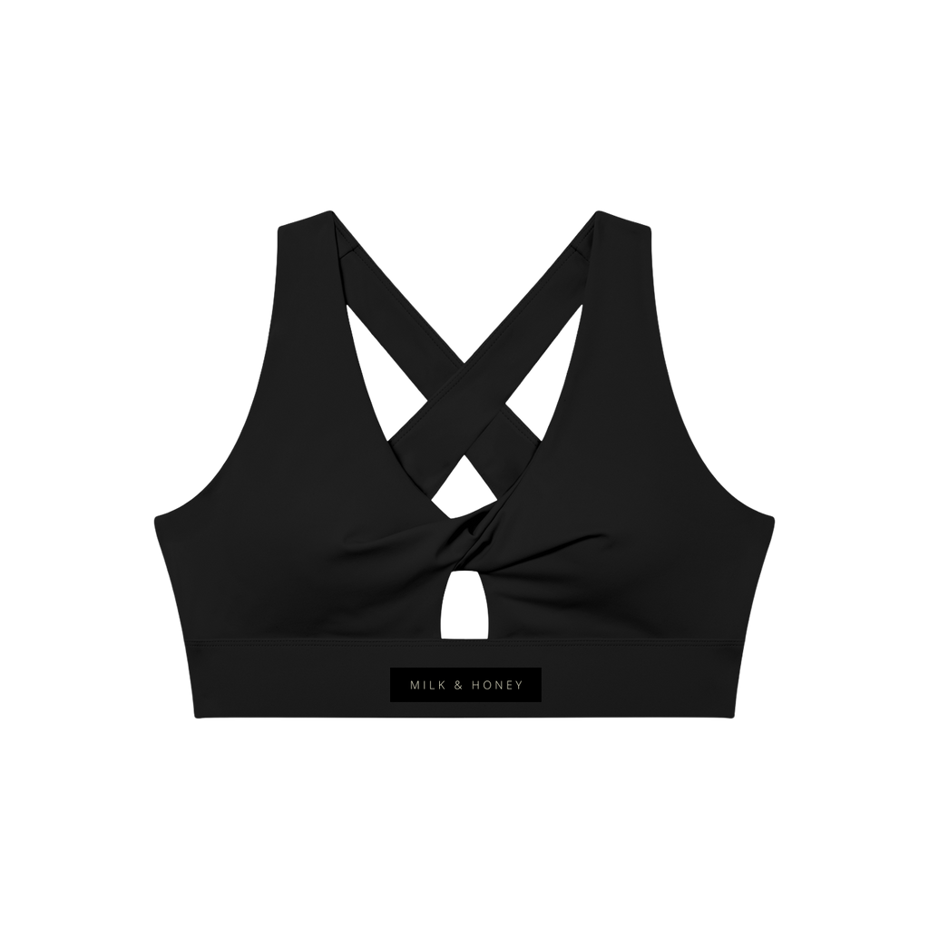 Twist-front sports bra with crossed back straps, small front keyhole and "MILK & HONEY" label on the band