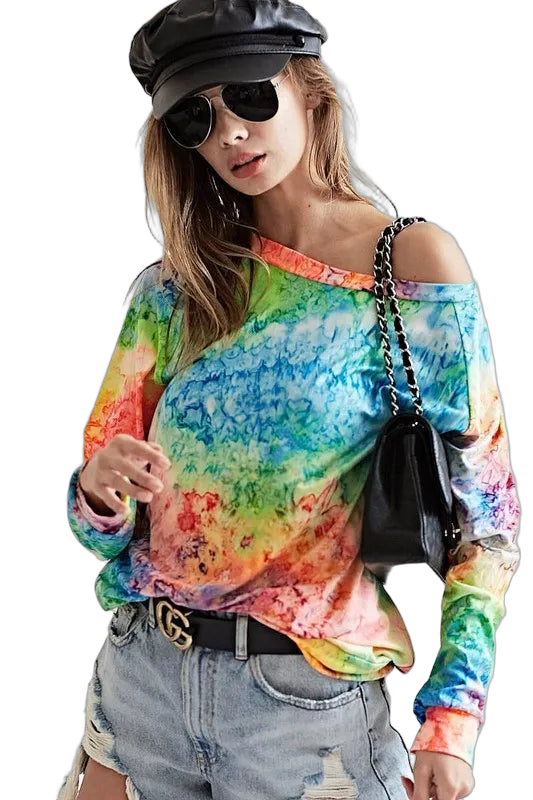 Model in rainbow tie-dye off-shoulder long-sleeve top, distressed denim shorts, black leather cap and aviator sunglasses