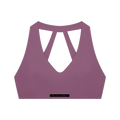 Plum purple cropped sports bra with deep V-front, crossed-back straps and elastic underband labeled 'MILK & HONEY'.