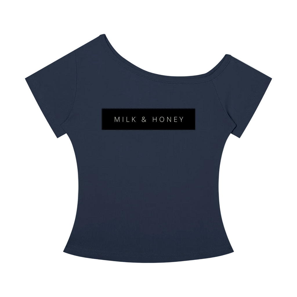 Off-the-shoulder short-sleeve top with centered black rectangle reading "MILK & HONEY" across the chest