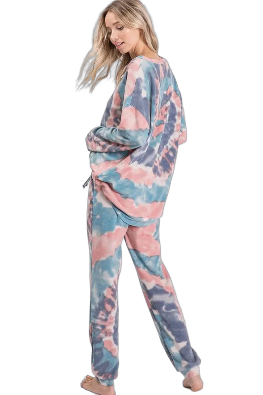 Model in pastel pink and blue tie-dye pants with drawstring waist and side pockets, paired with matching pullover