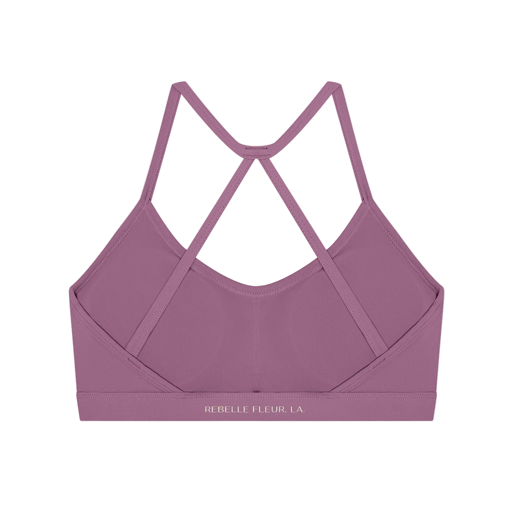 Back view of sleeveless crop sports bra with thin crisscross straps, wide elastic underband and small brand print on band