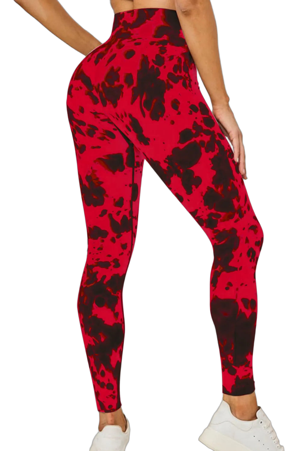 Back three-quarter view of model wearing red and black tie-dye high-waist full-length leggings with white sneakers