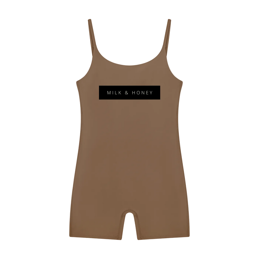 Brown sleeveless U-neck romper with thin straps and centered black 'MILK & HONEY' chest box, short legs