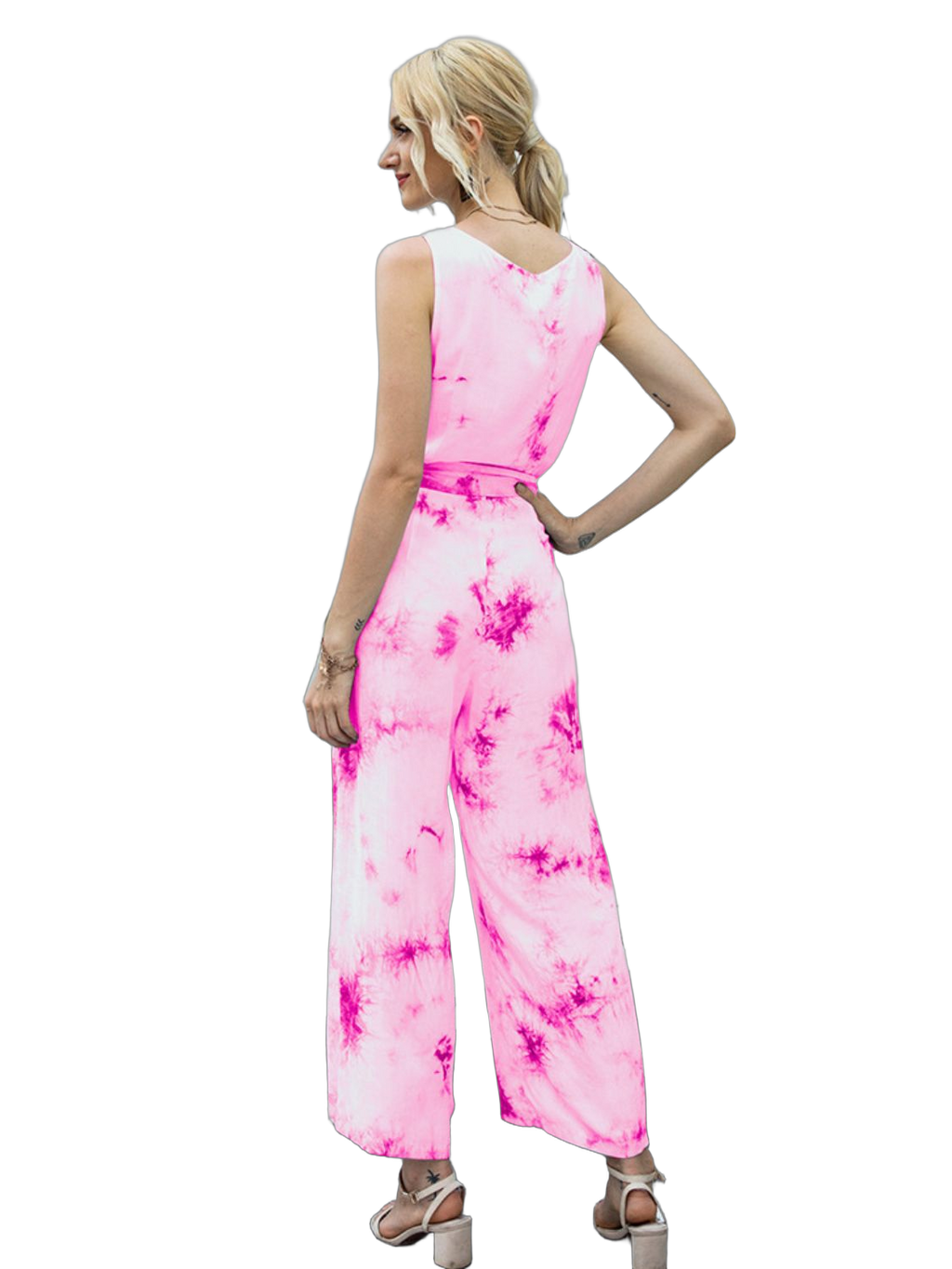 Back view of model wearing sleeveless pink tie-dye jumpsuit with tied waist, round neckline and wide-leg pants