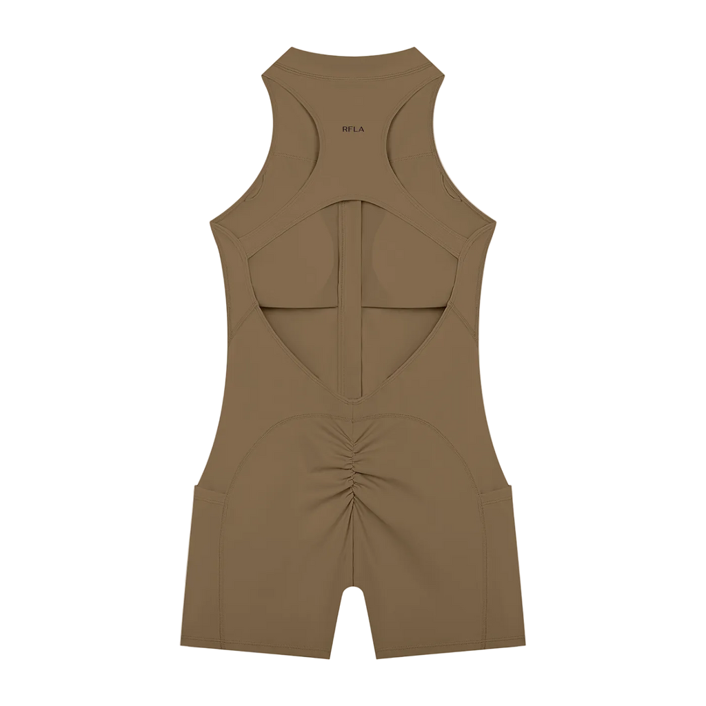Back view of sleeveless racerback romper in brown with large back cutout, vertical center seam, ruched rear and small…