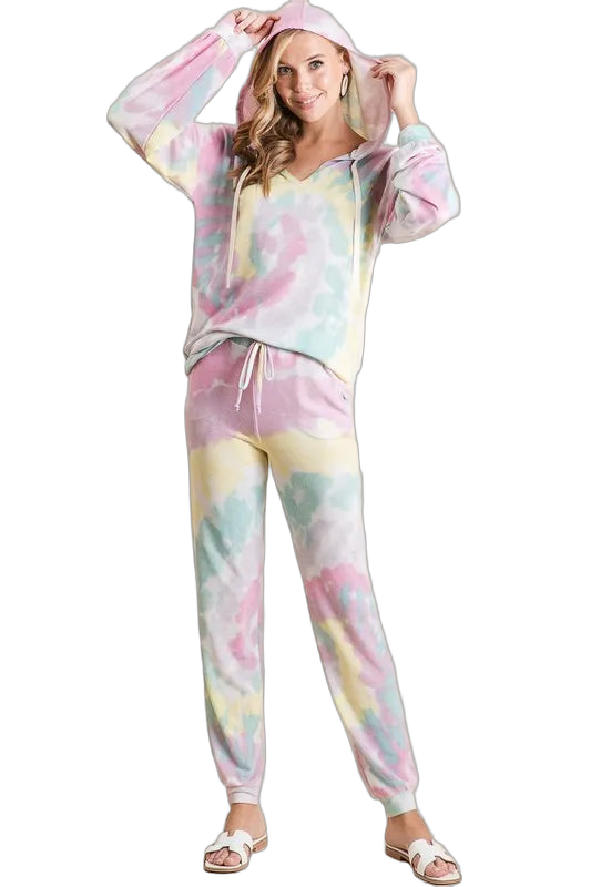 Woman wearing pastel tie-dye hooded sweatshirt and drawstring jogger pants with ankle cuffs