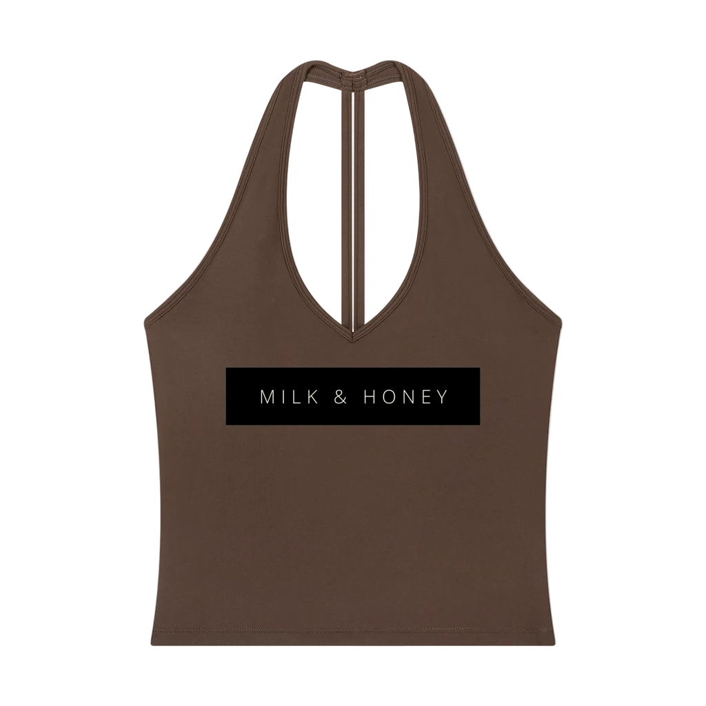 Brown halter V-neck cropped tank with narrow center-back strap and black rectangular 'MILK & HONEY' print across chest