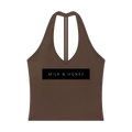 Brown halter V-neck cropped tank with narrow center-back strap and black rectangular 'MILK & HONEY' print across chest