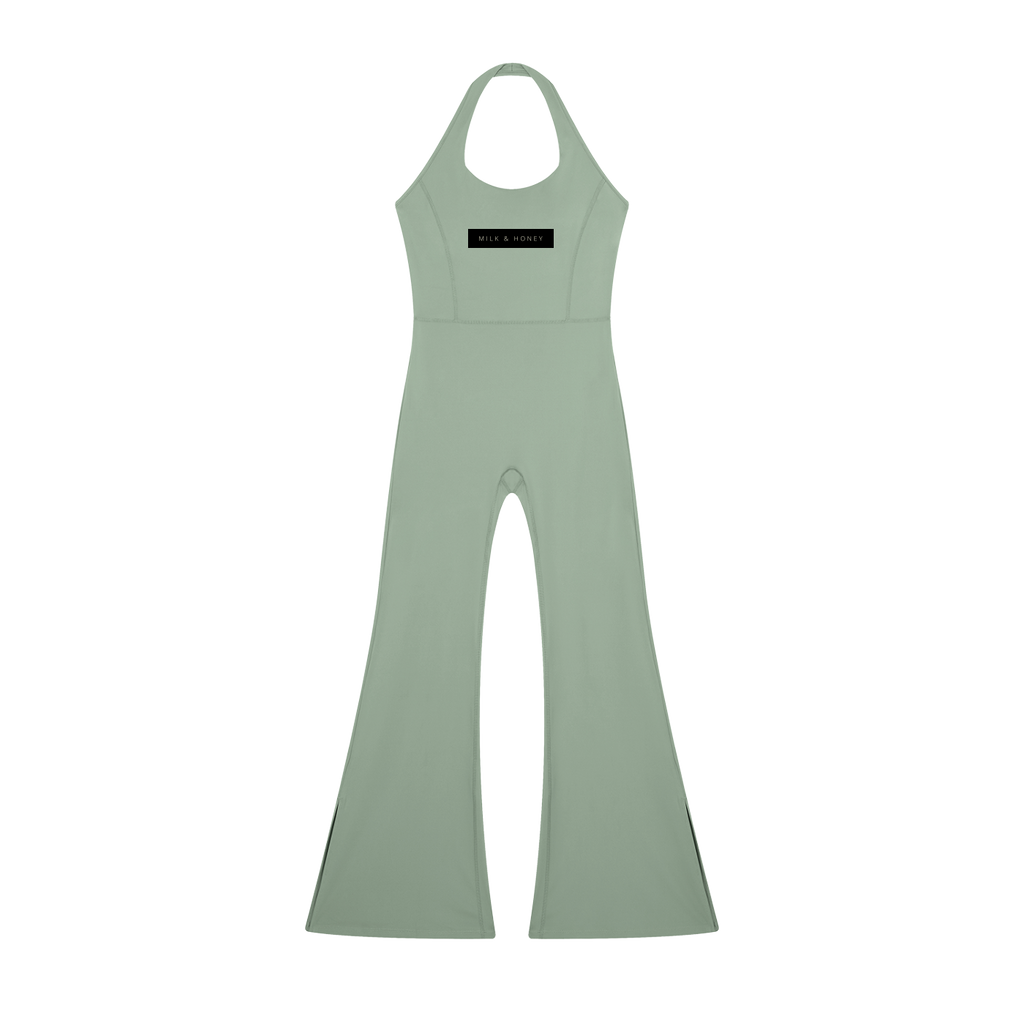 Halter-neck sleeveless flared jumpsuit in gray-green with high waist seam and black 'MILK & HONEY' chest label