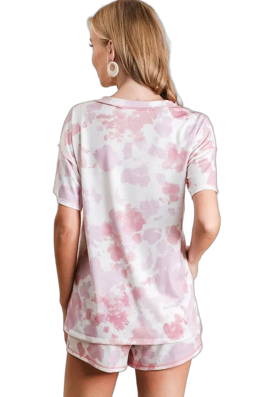 Back view of woman wearing pink-and-white tie-dye terry shorts and matching short-sleeve top