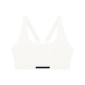 White crop sports bra with V-shaped racerback straps and wide elastic band labeled 'MILK & HONEY'