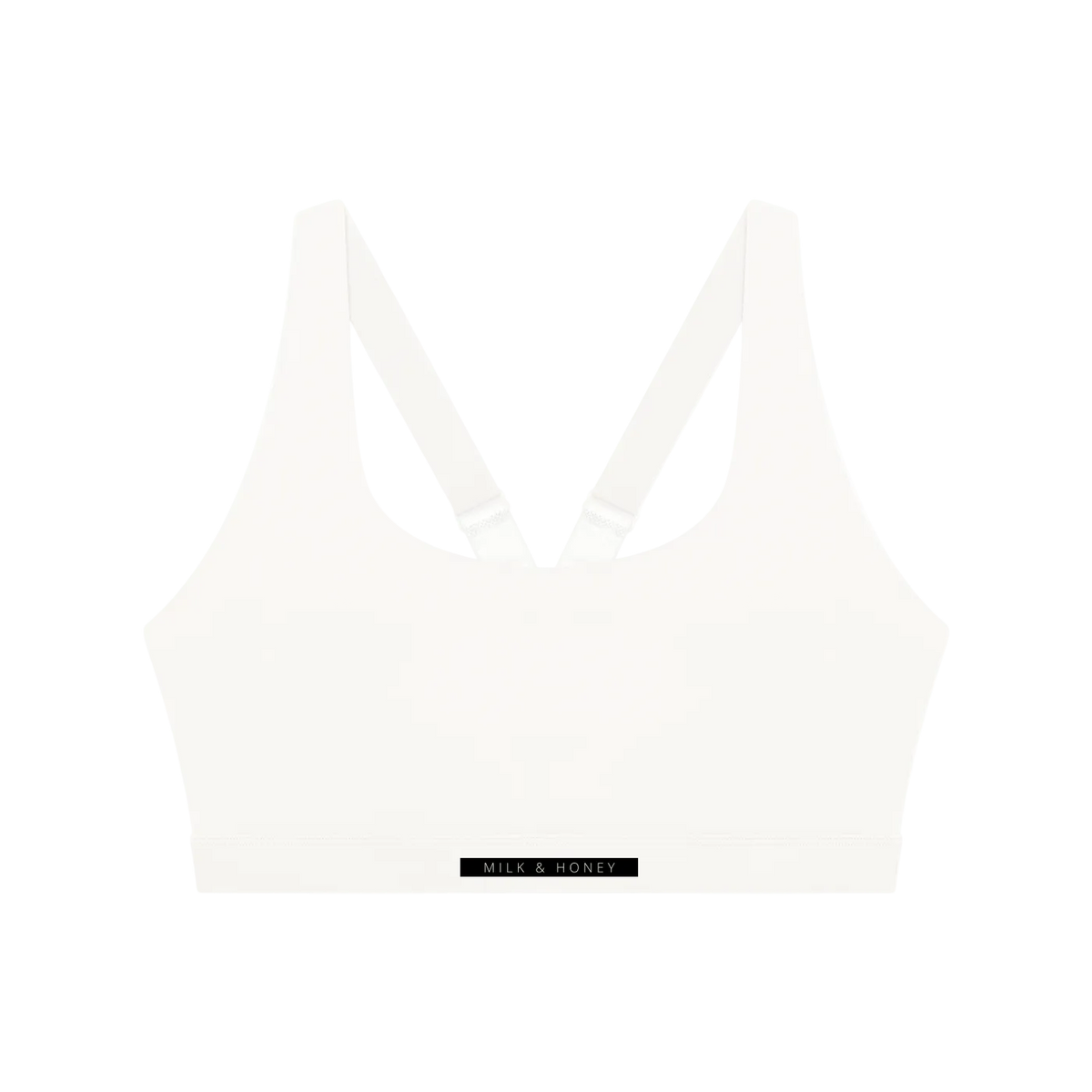 White crop sports bra with V-shaped racerback straps and wide elastic band labeled 'MILK & HONEY'