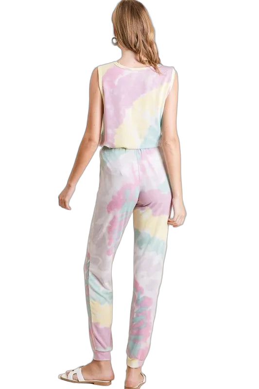 Back view of a woman wearing pastel tie-dye jogger pants with elastic waistband and ribbed ankle cuffs