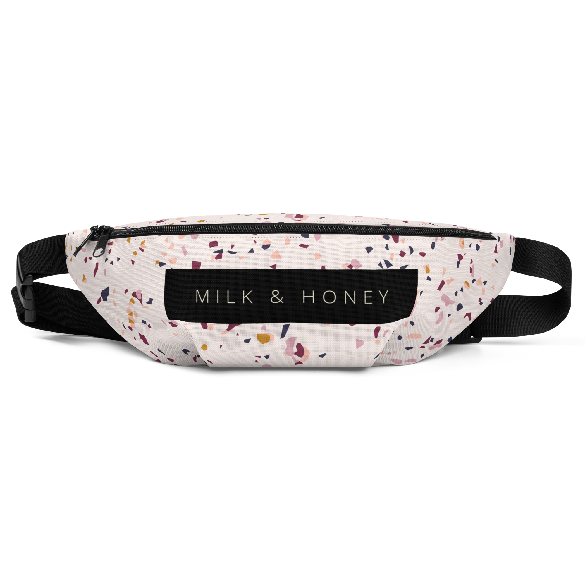Top view of terrazzo-pattern fanny pack with black zipper, dual sliders, MILK & HONEY label and adjustable black straps