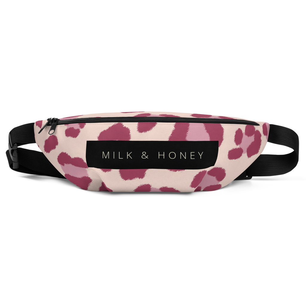 Top of waist bag with black zipper, "MILK & HONEY" label, pink spot print on light fabric and black adjustable strap