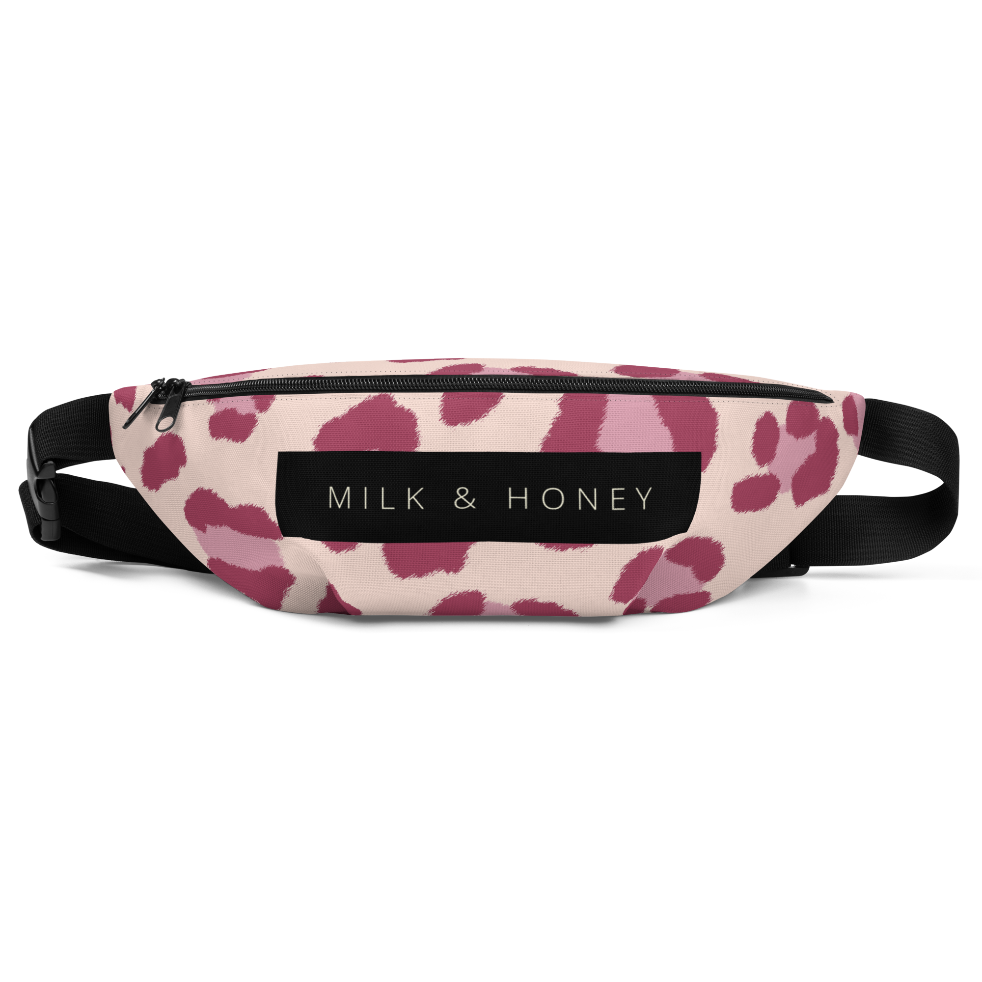 Top of waist bag with black zipper, "MILK & HONEY" label, pink spot print on light fabric and black adjustable strap