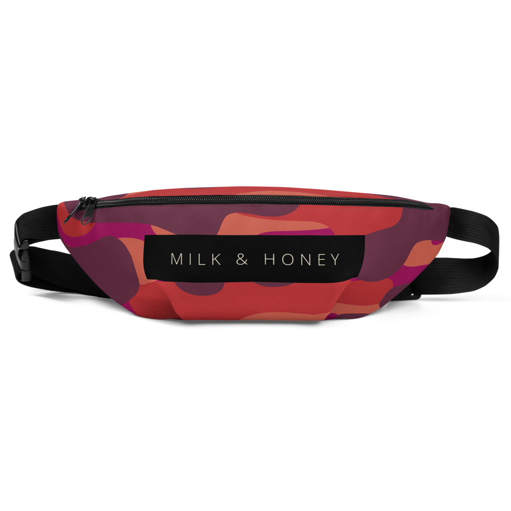 Zippered top of fanny pack with black 'MILK & HONEY' label, abstract red-orange-purple print, and adjustable black strap