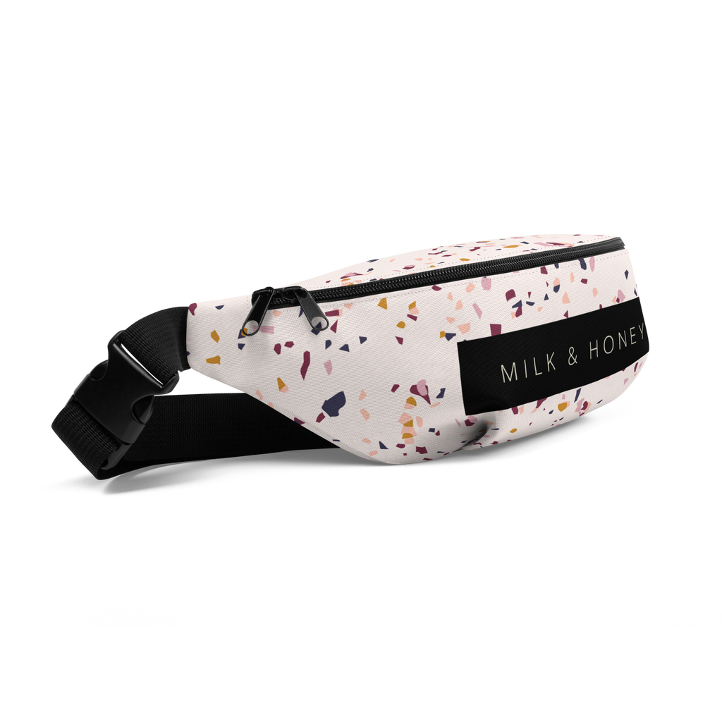 White fanny pack with multicolor confetti print, black dual zipper, black strap and plastic buckle, 'MILK & HONEY' label