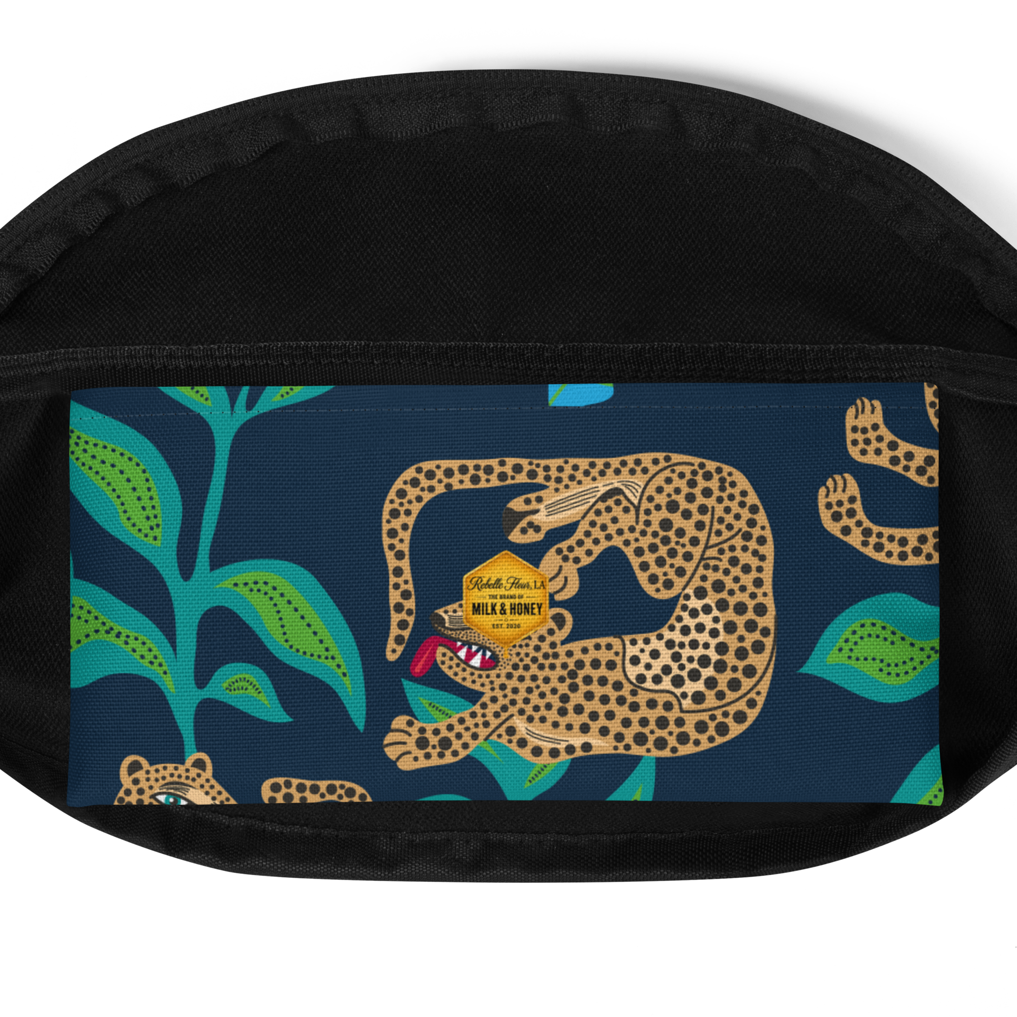 Front panel of waist bag with spotted leopard illustration, teal leaves on navy background and black zippered trim