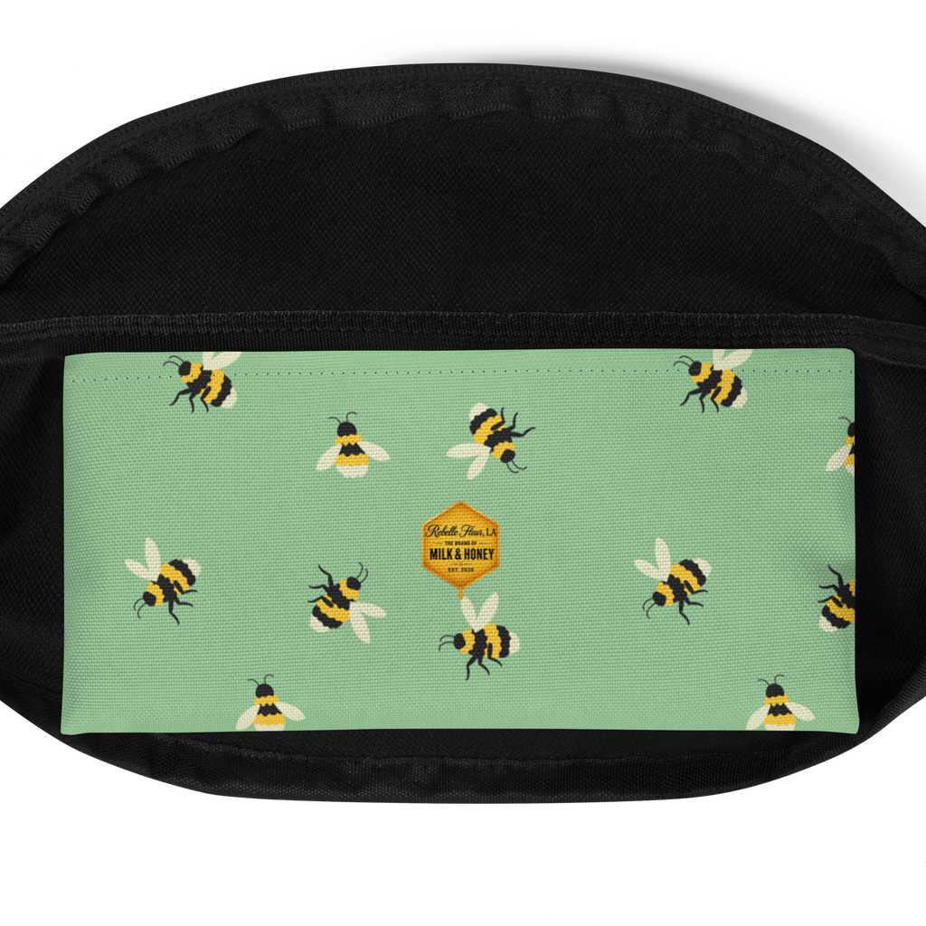 Mint-green front panel with repeating bee print and small hexagon label set against black fanny pack fabric