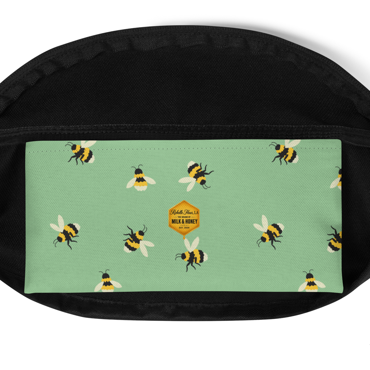 Mint-green front panel with repeating bee print and small hexagon label set against black fanny pack fabric