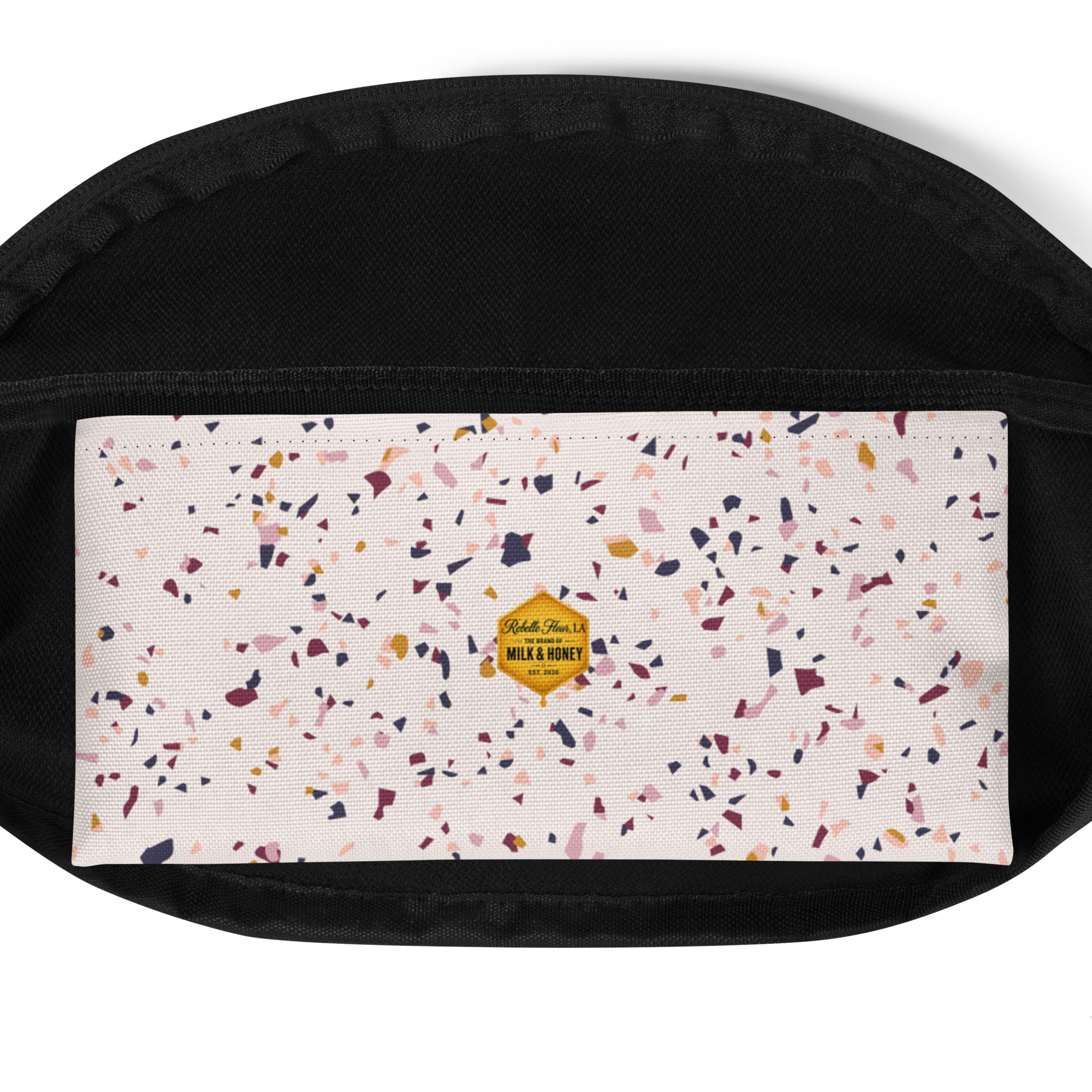 Black bag top with white confetti-patterned front panel and small yellow hexagon Milk & Honey label