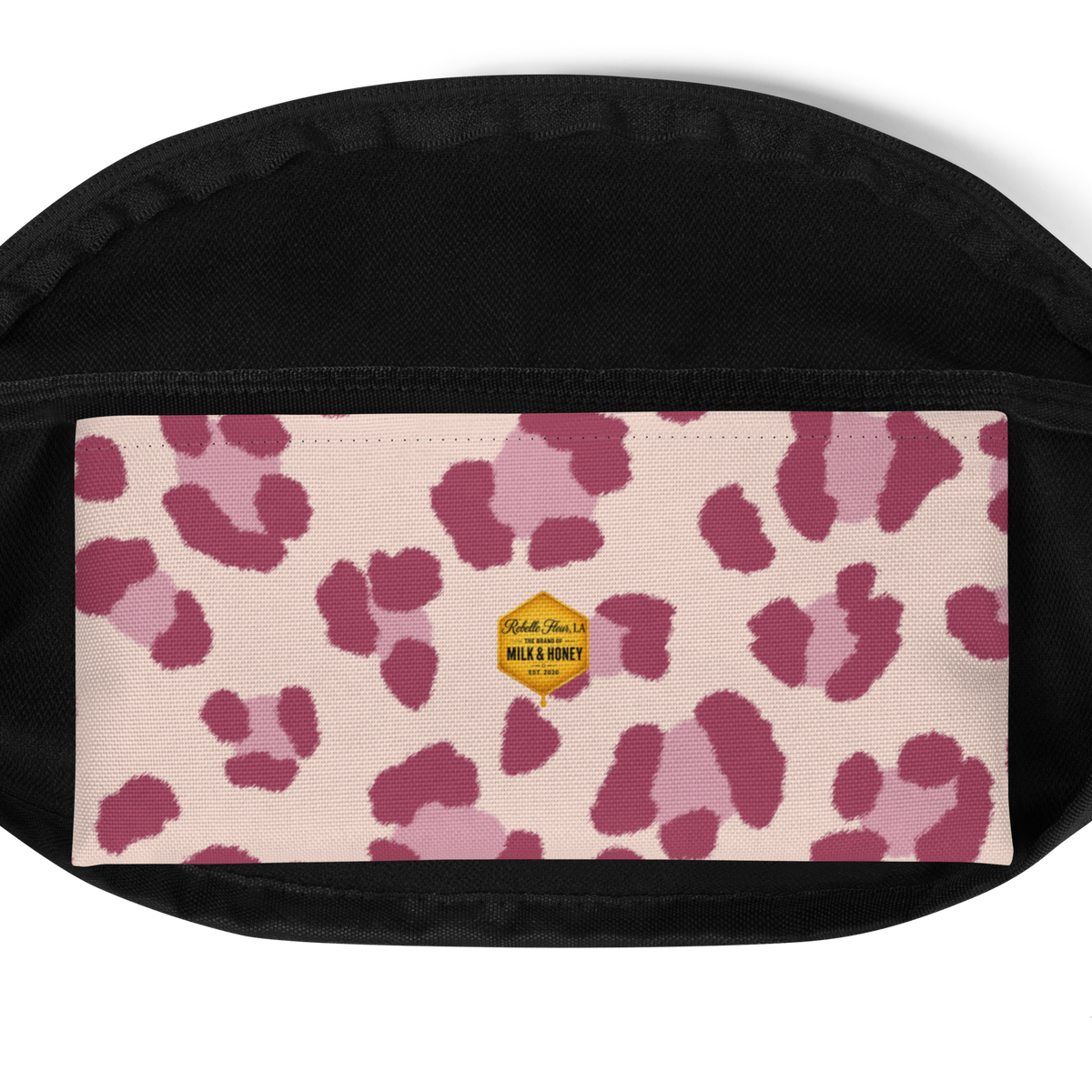 Black interior lining above a pale panel with pink spots and a small gold hexagon Milk & Honey label