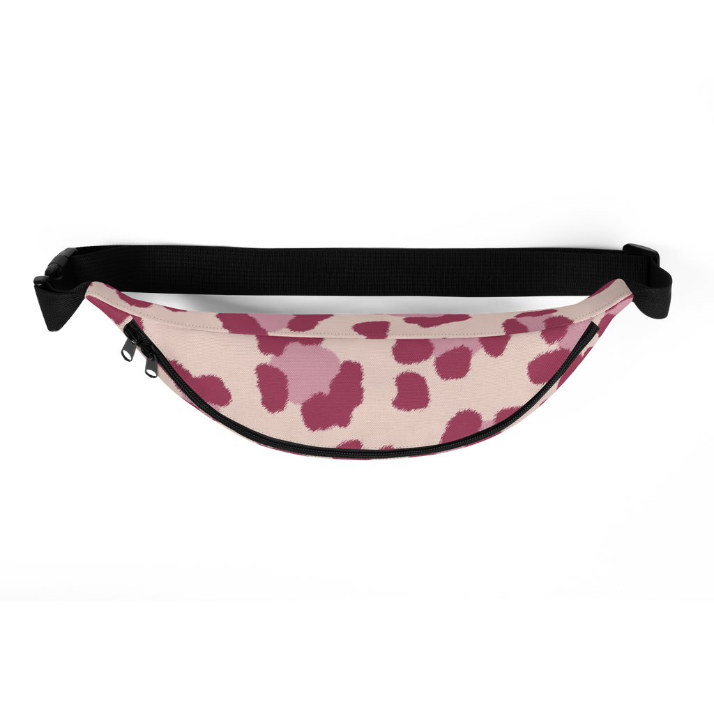 Black adjustable web strap with plastic buckle and zipper sliders above a pink patterned waist bag with darker spots