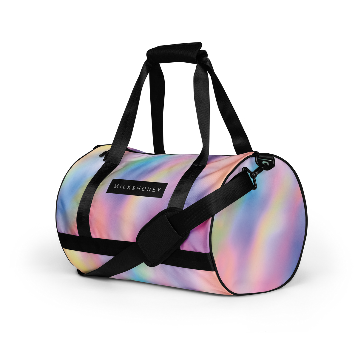 Top of pastel iridescent duffel with black padded handles, adjustable shoulder strap, metal clip and 'MILK&HONEY' logo patch