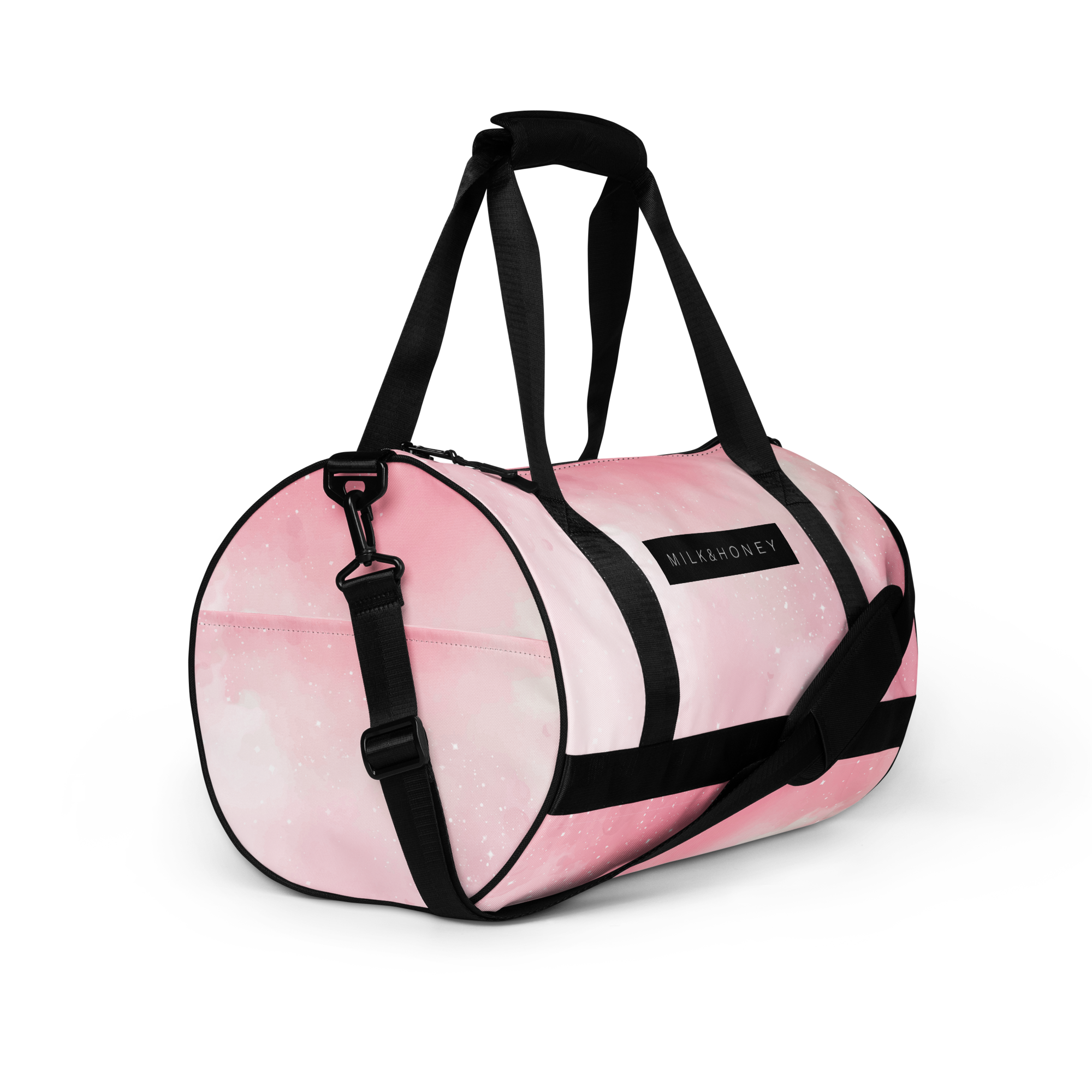 Pink duffel bag with black padded top handle, adjustable black straps, black hardware and MILK&HONEY label