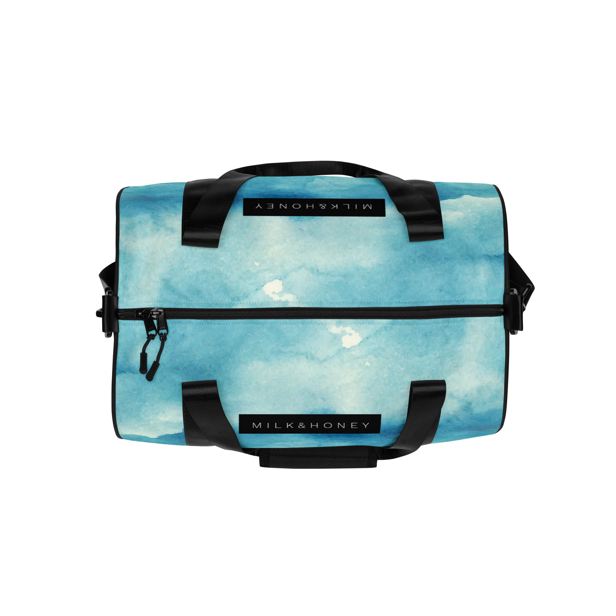 Top front of duffel with blue watercolor print, black padded handles, front zipper with dual pulls and 'MILK&HONEY' label